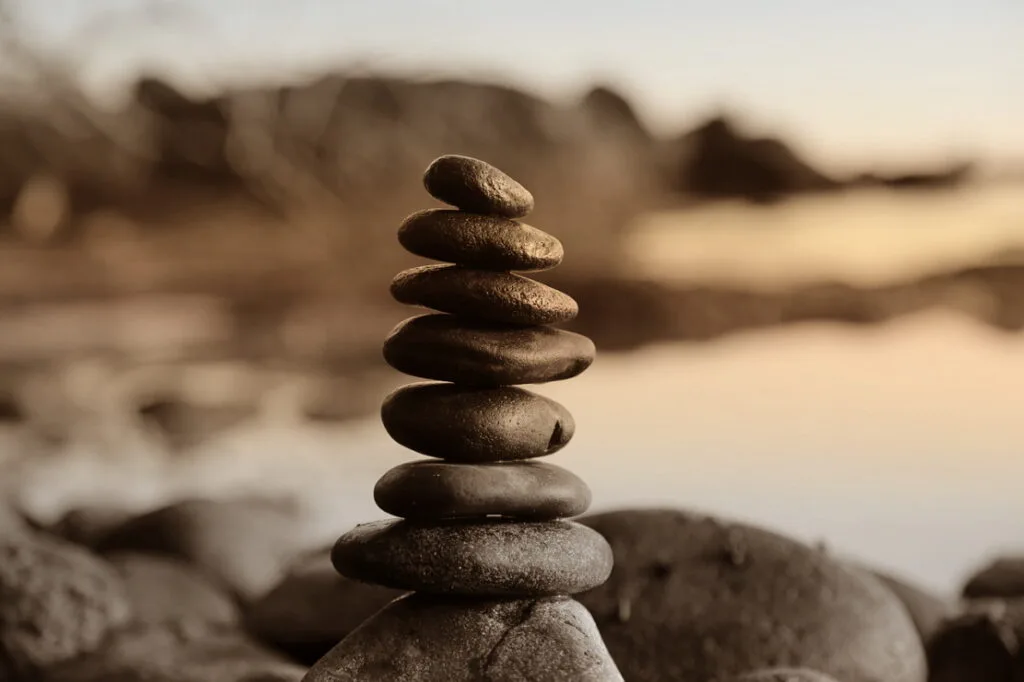 Stack of pebbles at a beach at sunset.